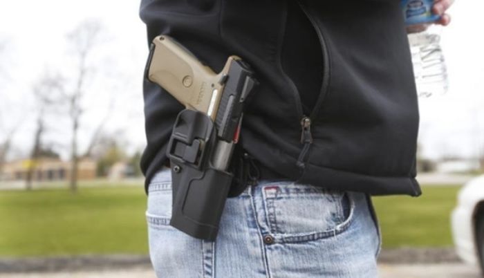 A gun rights supporter carries his Ruger model SR9 pistol on his hip during a rally in support of the Michigan Open Carry gun law in Romulus, Michigan on April 27, 2014.