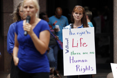 An anti-abortion activist stands with a sign in Austin, Texas July 8, 2013.