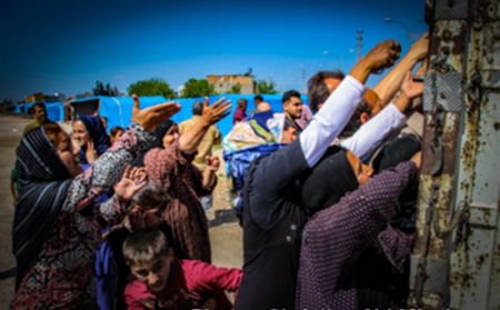 Syrian refugees beg for food at a refugee camp.