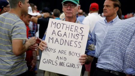 A man holds up a sign supporting North Carolina's anti-transgender bathroom law following Republican presidential nominee Donald Trump' campaign rally in Charlotte, North Carolina, U.S., August 18, 2016.