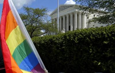 A rainbow-colored flag is seen outside the U.S. Supreme Court in Washington, U.S., on April 27, 2015.