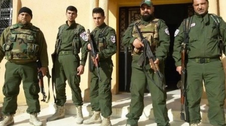 A group of Assyrian Christian soldiers just outside their headquarters somewhere in Syria.