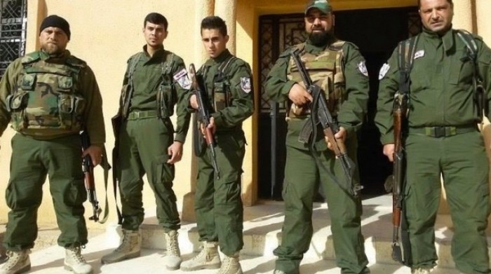 A group of Assyrian Christian soldiers just outside their headquarters somewhere in Syria.