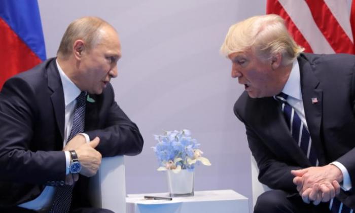 U.S. President Donald Trump speaks with Russian President Vladimir Putin during their bilateral meeting.