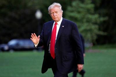 U.S. President Donald Trump waves as walks on the South Lawn of the White House upon his return to Washington, U.S., from the G20 Summit in Hamburg, Germany, July 8, 2017.