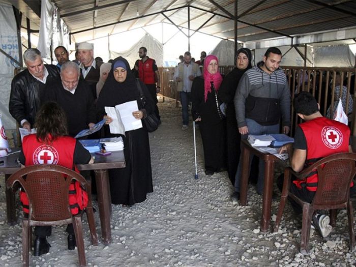 Syrian refugees line up to receive aid for the winter from the U.N. refugee agency (UNHCR) in Tripoli, northern Lebanon, on Nov. 18, 2015.