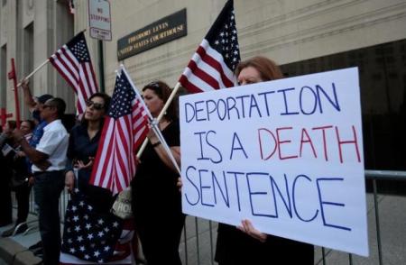 Protesters rally outside the federal court just before a hearing to consider a class-action lawsuit filed on behalf of Iraqi nationals facing deportation, in Detroit, Michigan, U.S., June 21, 2017.