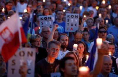 People gather in front of the Supreme Court during a protest against the Supreme Court legislation in Warsaw, Poland, July 22, 2017.