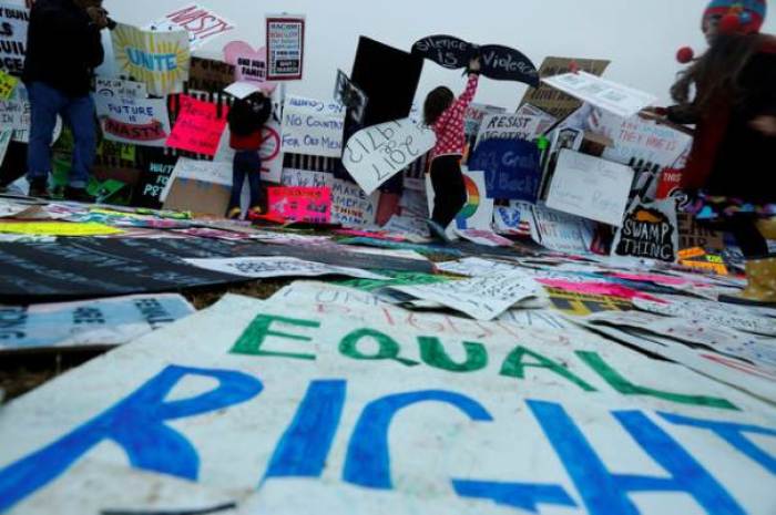 Children use protest signs to build a wall while taking part in the Women's March to protest Donald Trump's inauguration as the 45th president of the United States close to the White House in Washington, January 21, 2017.