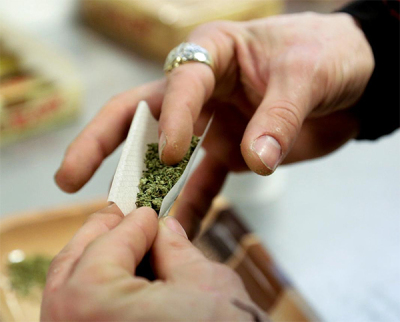 A participant practices rolling a joint at the Cannabis Carnivalus 4/20 event in Seattle, Washington.