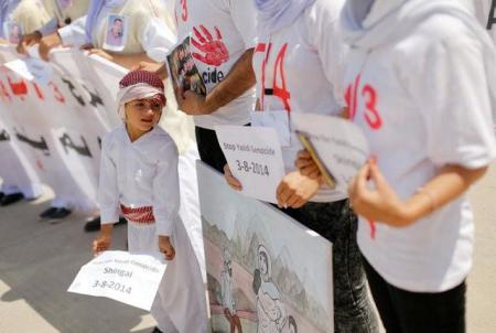 Yazidis attend a commemoration of the third anniversary of the Yazidi genocide in Sinjar region, Iraq, August 3, 2017.