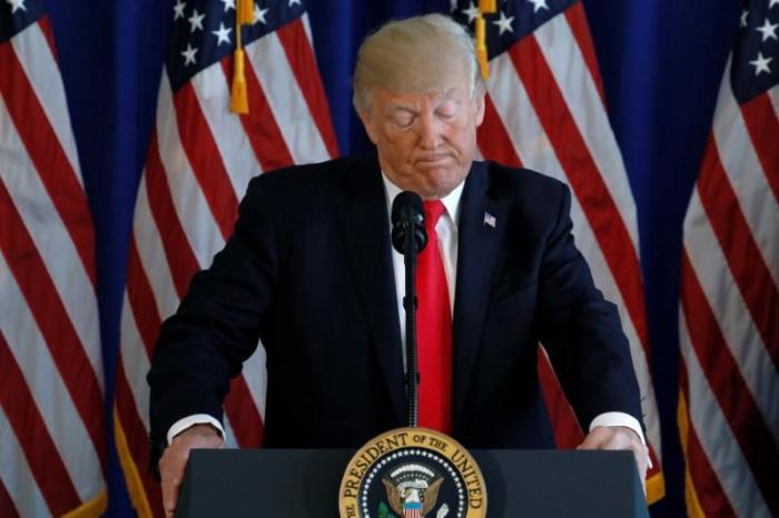 U.S. President Donald Trump pauses during remarks on the protests in Charlottesville, Virginia, from his golf estate in Bedminster, New Jersey, U.S. August 12, 2017.