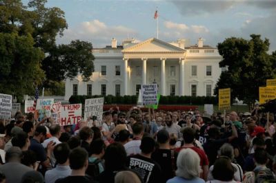 People gather for a vigil in response to the death of a counter-demonstrator at the 'Unite the Right' rally in Charlottesville, outside the White House in Washington, U.S. August 13, 2017.