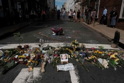 Flowers and a photo of car ramming victim Heather Heyer lie at a makeshift memorial in Charlottesville, Virginia, August 13, 2017.