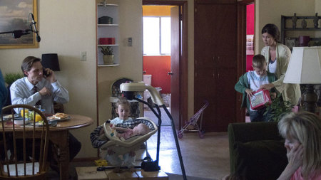 Mitch Davis busily talks on the phone about work while eating breakfast at home surrounded by his three young kids and his wife in 2017 film 'The Stray.'