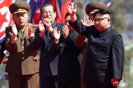 North Korean leader Kim Jong Un waves to people cheering during an opening ceremony of a newly constructed residential complex in Ryomyong street in Pyongyang, North Korea April 13, 2017.