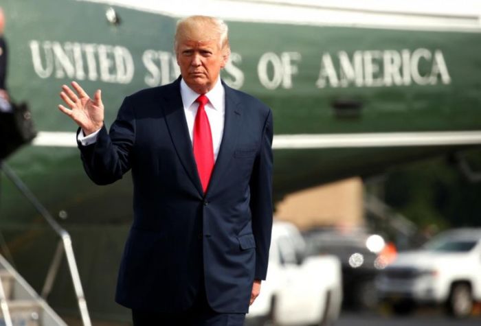 U.S. President Donald Trump waves after arriving by helicopter at Morristown Airport to depart aboard Air Force One bound for Washington in Morristown, New Jersey, U.S. August 14, 2017.