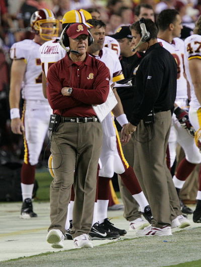 Former Washington Redskins head coach Joe Gibbs, who coached the Redskins from 1981-1992 and then again from 2004-2007, walks the sideline during a game against the Minnesota Vikings on September 11, 2006.