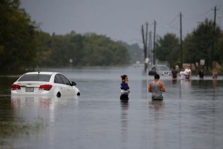 Residents wade through flood waters in Houston, Aug. 28, 2017.