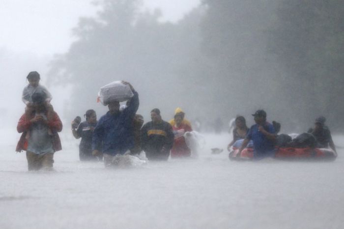 Residents wade through flood waters from Tropical Storm Harvey in Beaumont Place, Houston, Texas, U.S., on August 28, 2017.