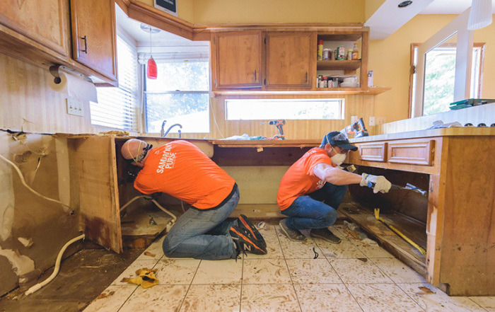 Samaritan's Purse volunteers in Texas demolish cabinets from a kitchen damaged by Hurricane Harvey in Southeast, Texas in this undated photo.