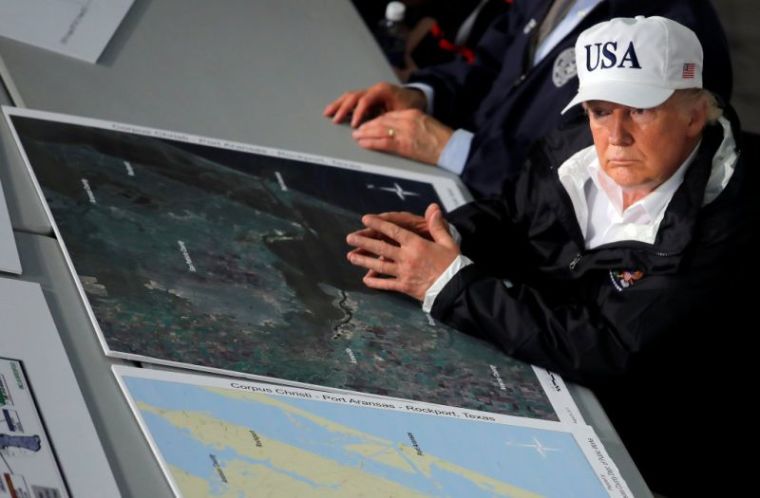 U.S. President Donald Trump and first lady Melania Trump (R) receive a briefing on Tropical Storm Harvey relief efforts with Texas Governor Greg Abbott (2ndL) in Corpus Christi, Texas, U.S., August 29, 2017.