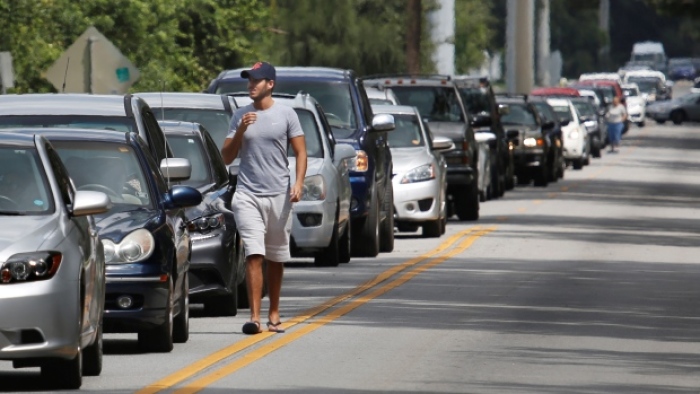 Motorists form a long line to get sandbags at Kissimmee, Fla., on Thursday to prepare for the arrival of Hurricane Irma.