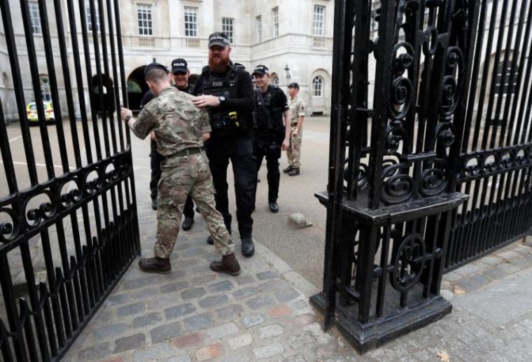 Armed police officers patrol along walk from Horse Guards Parade on to Whitehall in London, Britain, September 16, 2017.