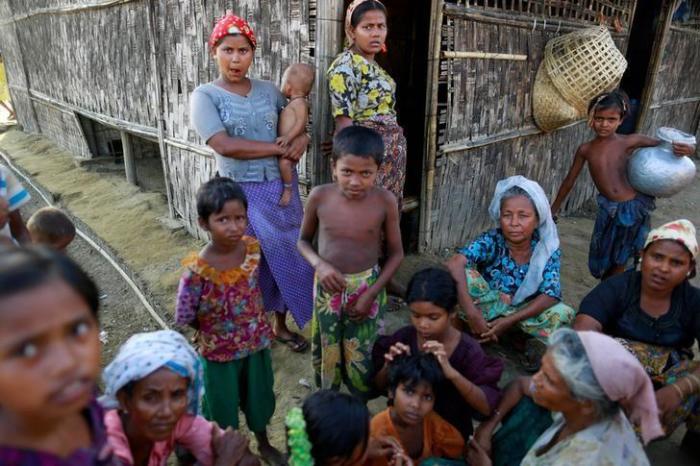 Rohingya Muslims pass time near their shelter at a refugee camp outside Sittwe, Myanmar, June 4, 2014.