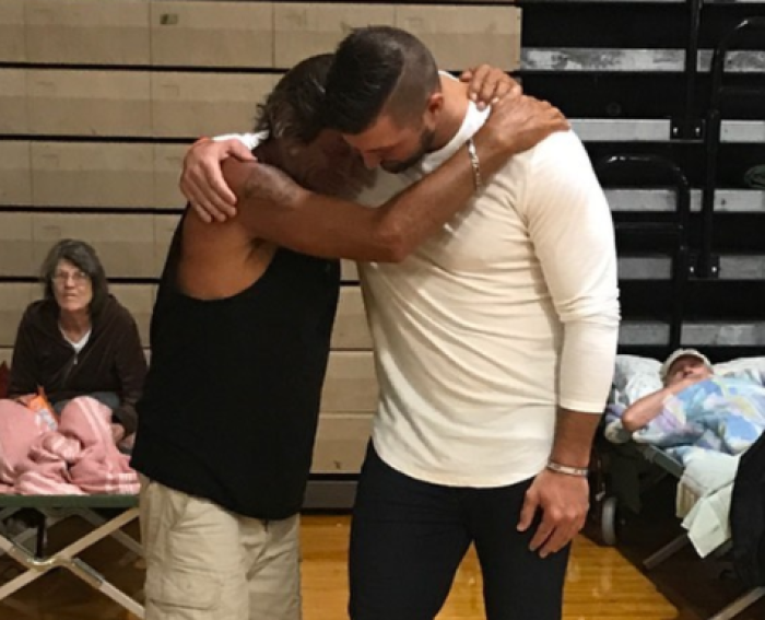 Tim Tebow shares a hug with one of the victims of Hurricane Irma.