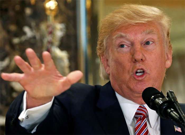 Credit : US President Donald Trump speaks in front of his Trump Tower residence.