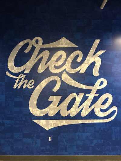 The painting of the words 'Check the Gate' near the theater viewing room is a reminder to Pure Flix staff to check oneself and try to be excellent in all things before the Lord.