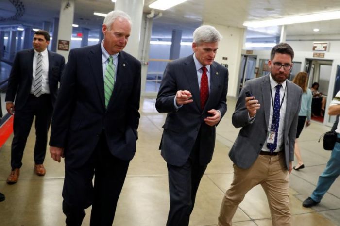 Sen. Bill Cassidy (R-LA), accompanied by Sen. Ron Johnson (R-WI) at left, speaks with reporters ahead of the party luncheons on Capitol Hill in Washington, U.S., September 26, 2017.