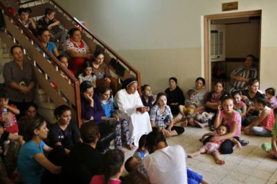 Displaced Iraq Christians who fled from Islamic State militants in Mosul, pray at a school acting as a refugee camp in Erbil, Iraq, September 6, 2014.