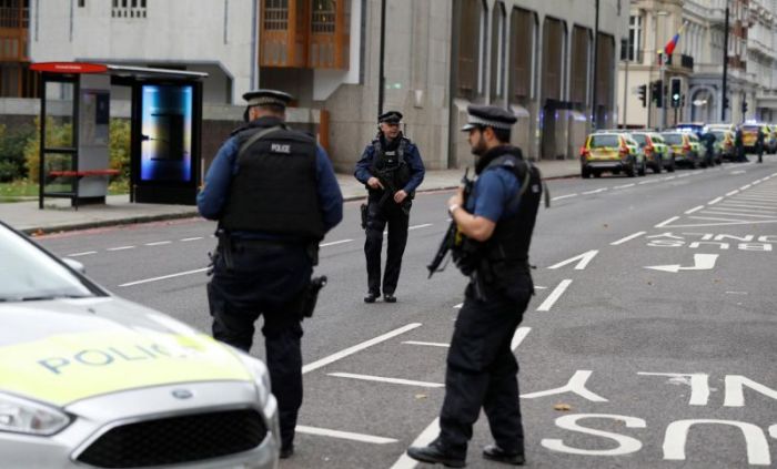 Police officers stand in the road near the Natural History Museum, after a car mounted the pavement injuring a number of pedestrians, police said, in London, Britain, October 7, 2017.