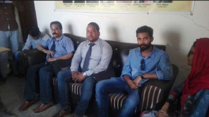 Pastors from Bahawalpur, Pakistan sit on a couch as they meet with an officer from the British Pakistani Christian Association in this photo taken in October 2017.