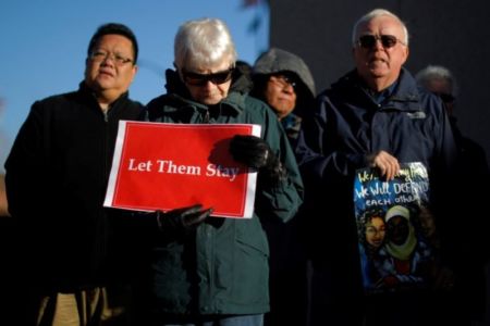 Demonstrators hold an 'Interfaith Prayer Vigil for Immigrant Justice' outside the federal building, where ethnic Chinese Christians who fled Indonesia after wide scale rioting decades ago and overstayed their visas in the U.S. must check-in with ICE, in Manchester, New Hampshire, U.S., October 13, 2017.