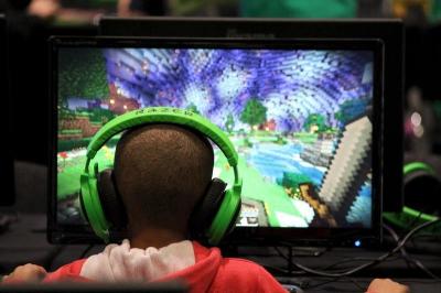 A child plays video game Minecraft at the Minecon convention in London July 4, 2015.