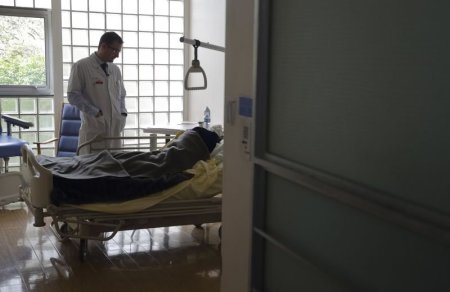 Doctor Stephane Mercier visits a patient at the palliative care unit of the AP-HP Paul-Brousse hospital in Villejuif near Paris.