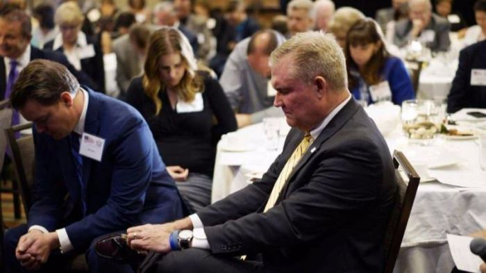 Chad Connelly, director of Faith Engagement for the Republican National Committee, prays with a group of pastors at an American Renewal Project dinner in Westminster, Colorado October 23, 2014.