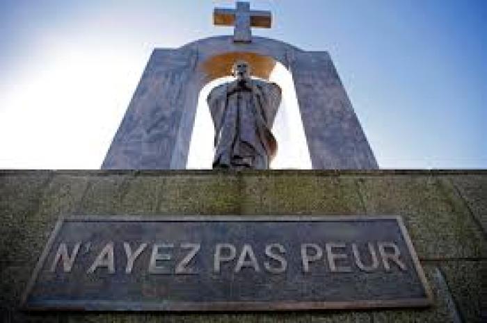 A statue of the late Pope John Paul II stands in Ploermel January 25, 2014. The sign reads: 'Do not be afraid.'