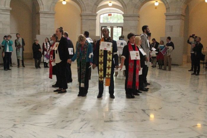 Christian leaders and activists hold hands and sing in an unlawful demonstration inside of the Russell Senate office building in Washington, D.C. on November 1, 2017.