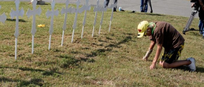 Brandy Jones prays in front of 26 crosses erected near the site of the shooting at the First Baptist Church of Sutherland, Texas, U.S., November 6, 2017.