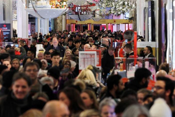 Bargain-hunters walk through Macy's Herald Square store during early opening for Black Friday sales in Manhattan, New York, November 24, 2016.