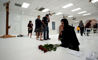 A woman prays in the First Baptist Church of Sutherland Springs as the church was opened to the public as a memorial to those killed, in Texas, November 12, 2017.