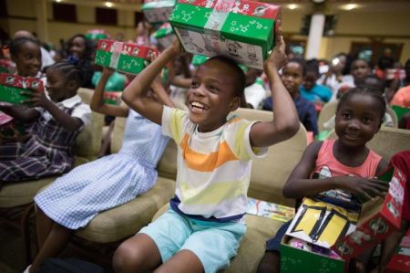 Children displaced from their homes in Barbuda receive Operation Christmas Child shoeboxes during an early distribution on the island of Antigua on Nov. 7, 2017.