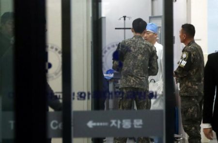 A South Korean soldier talks with a surgeon at a hospital where a North Korean soldier who defected to the South is hospitalized.