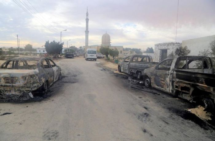 Damaged vehicles are seen after a bomb exploded at Al Rawdah mosque in Bir Al-Abed, Egypt, November 25, 2017.