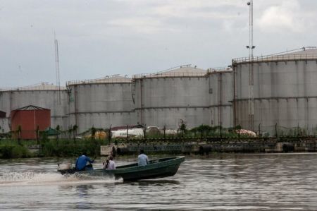 A boat travels down a river near the southeastern oil city of Warri, in Delta state, Nigeria June 18, 2017.