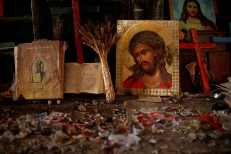 Burned candles as seen as Iraqis attend a Palm Sunday procession in the burnt out main church of Qaraqosh, Iraq, April 9, 2017.